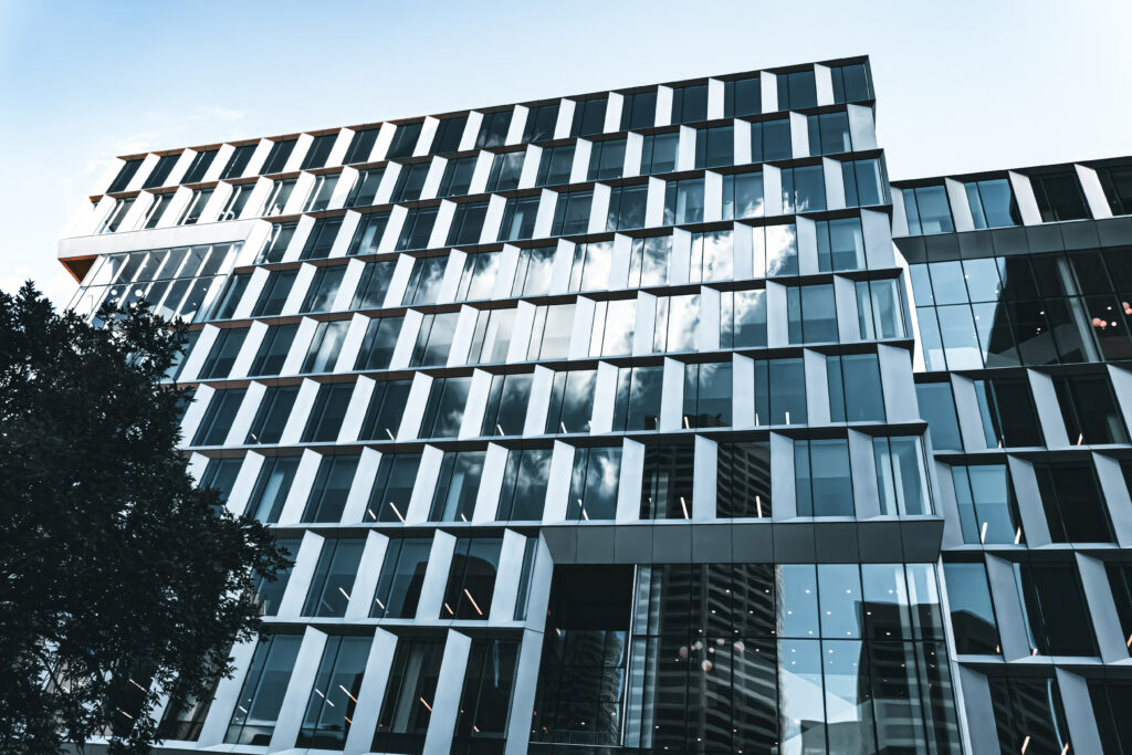 Modern Glass Facade Wallpaper: Sleek Architecture & Urban Reflection