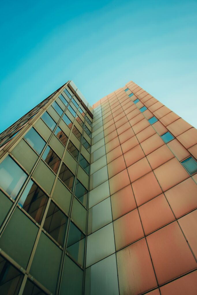 Stunning Bottom-Up View of Modern High-Rise Building Wallpaper
