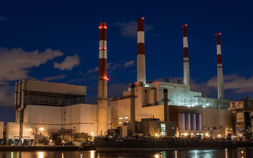 Modern industrial factory at night with smokestacks red lights blue sky geometric architecture Wallpaper
