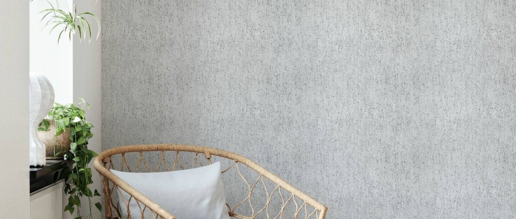 Light grey rough concrete wall texture wallpaper with subtle speckled finish in modern room
