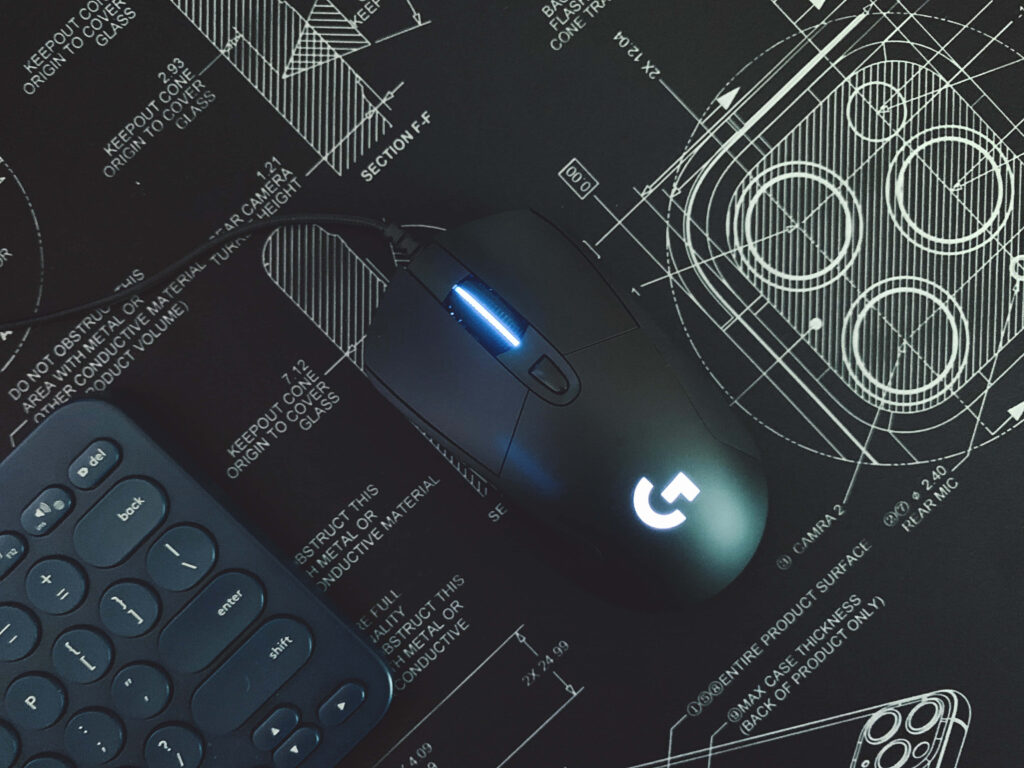 Modern Logitech Gaming Mouse on Tech Blueprint Wallpaper Background