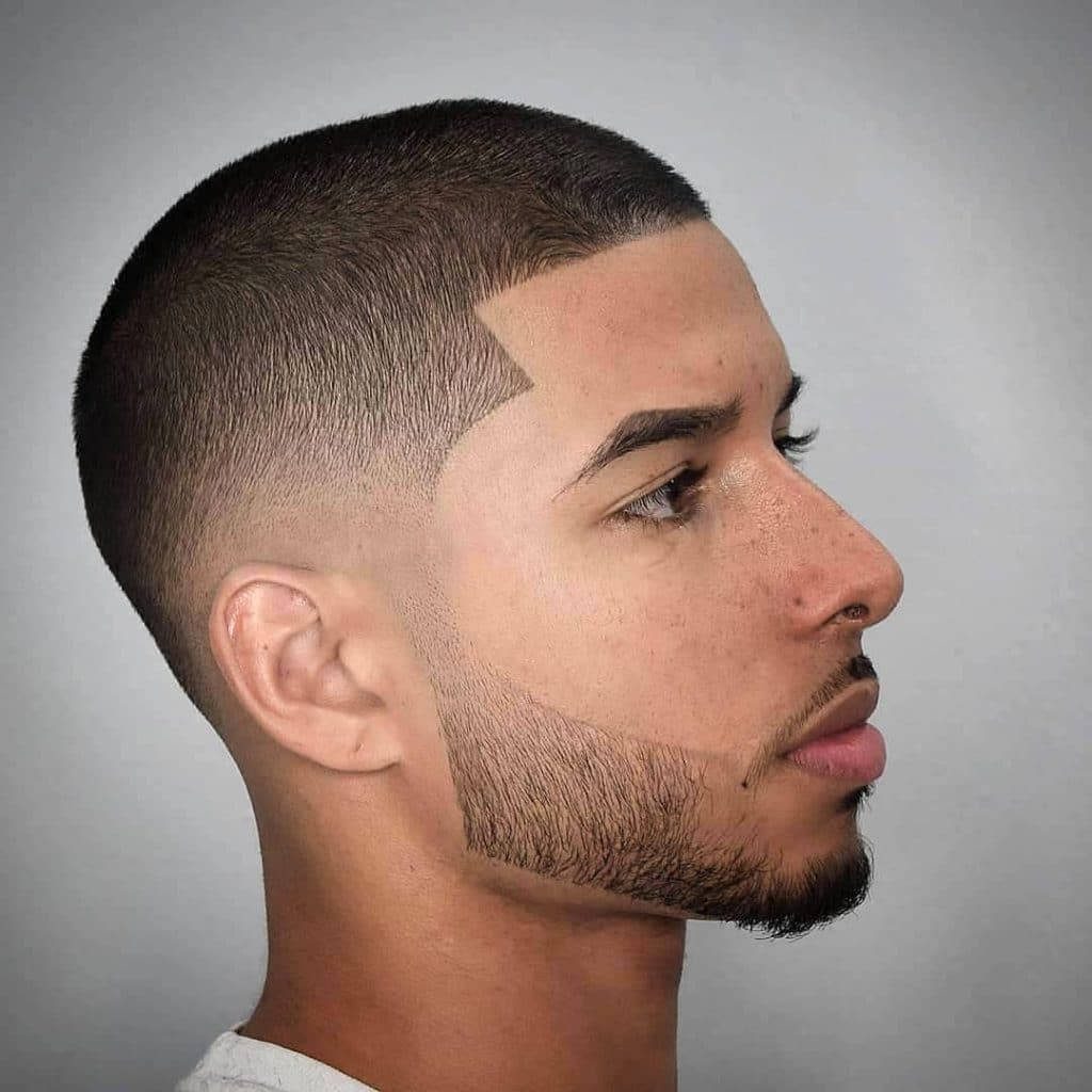 Profile portrait of man with sharp buzz cut precise skin fade and groomed beard in neutral light Wallpaper