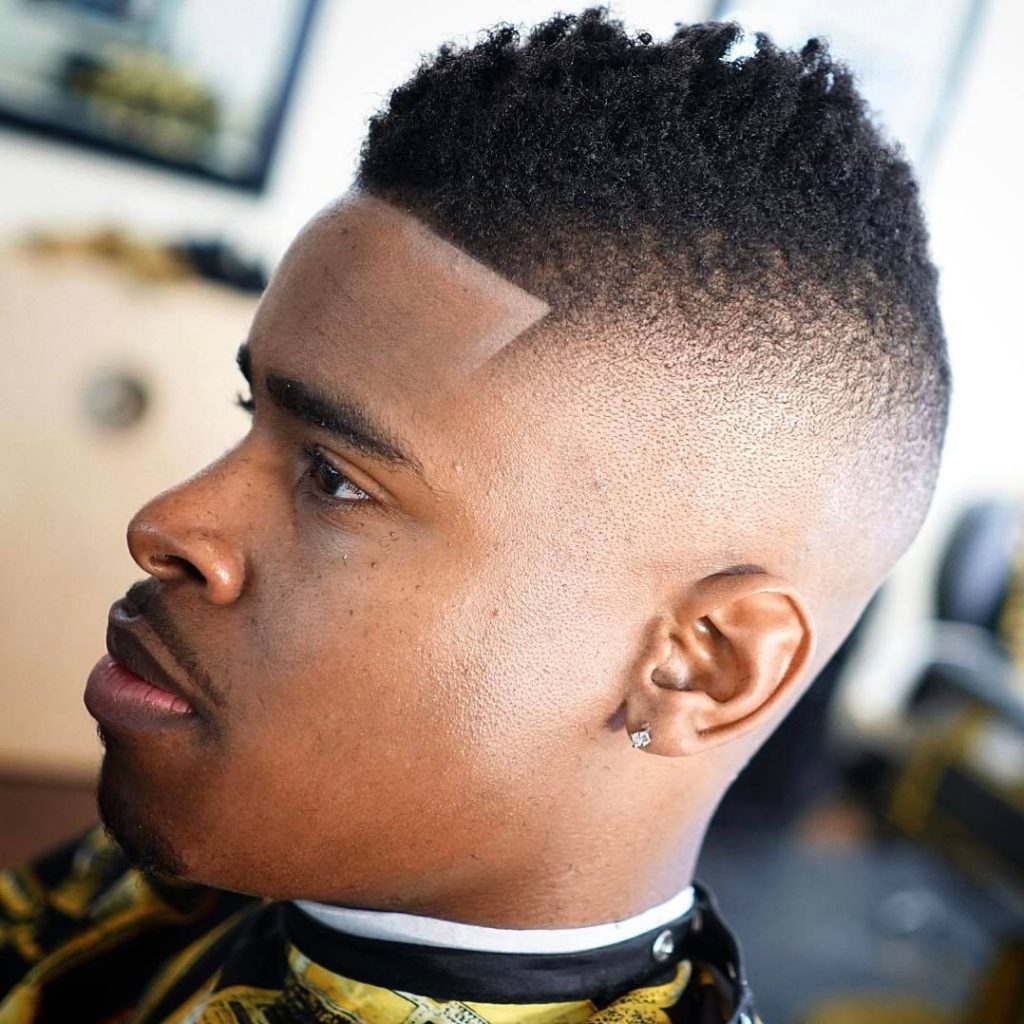 Sharp modern mohawk fade with textured afro top and clean line up professional barbershop style Wallpaper