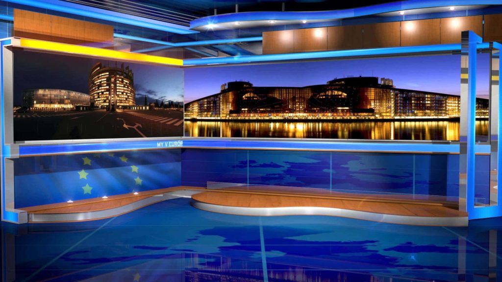Modern news studio with CGI video walls showing European Parliament Strasbourg at night Wallpaper