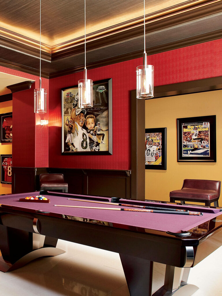 Modern billiards room with purple pool table red walls pendant lights and sports artwork background Wallpaper
