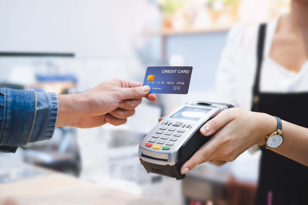 Woman hands credit card to man at POS terminal modern retail transaction technology payment Wallpaper