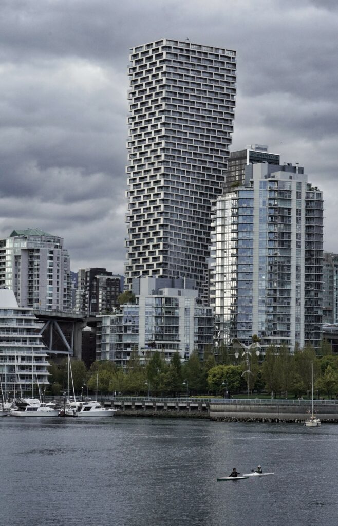 Modern Riverside Cityscape Wallpaper with Unique Skyscraper Design