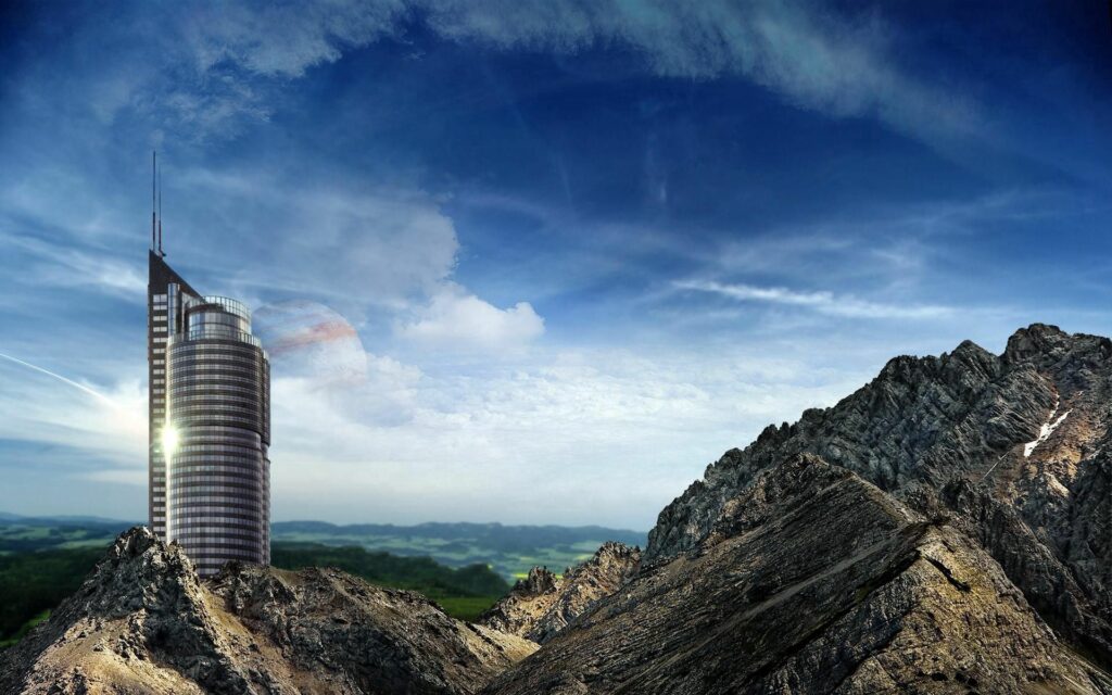 Modern skyscraper reflects light standing tall among rugged mountains and green landscapes Wallpaper