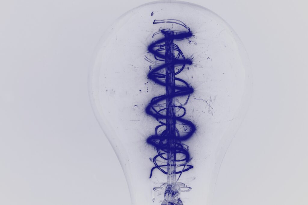 Artistic Blue Spiral Filament Light Bulb Closeup - Modern Wallpaper