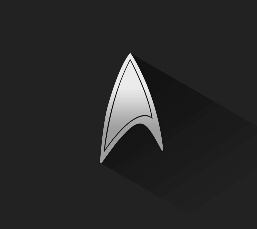Sleek Star Trek Wallpaper: Silver Starfleet Insignia on Dark Background