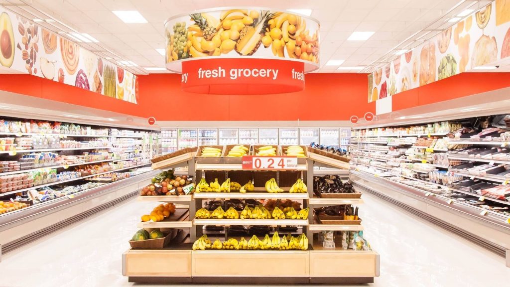 Brightly lit modern Target produce aisle with vibrant bananas and organized grocery shelves wallpaper
