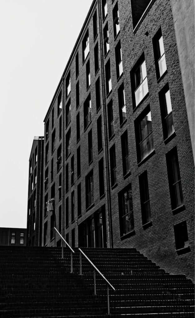 Modern Building Wallpaper: Textured Brick Façade & Metal Stairs
