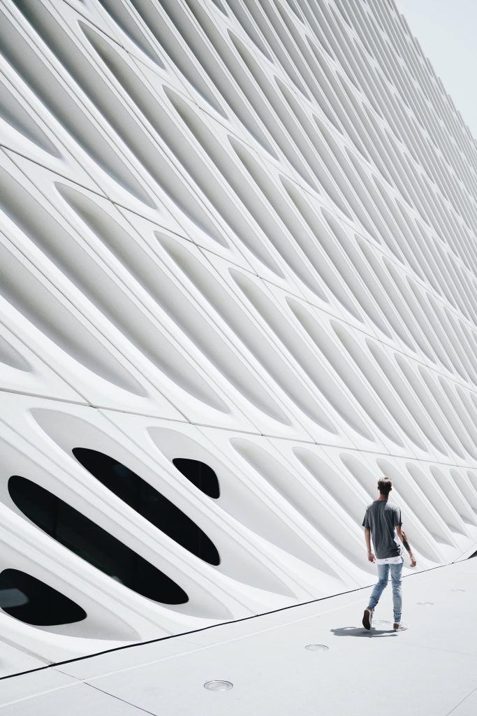 Person walking by white honeycomb facade of The Broad museum Los Angeles modern architecture wallpaper