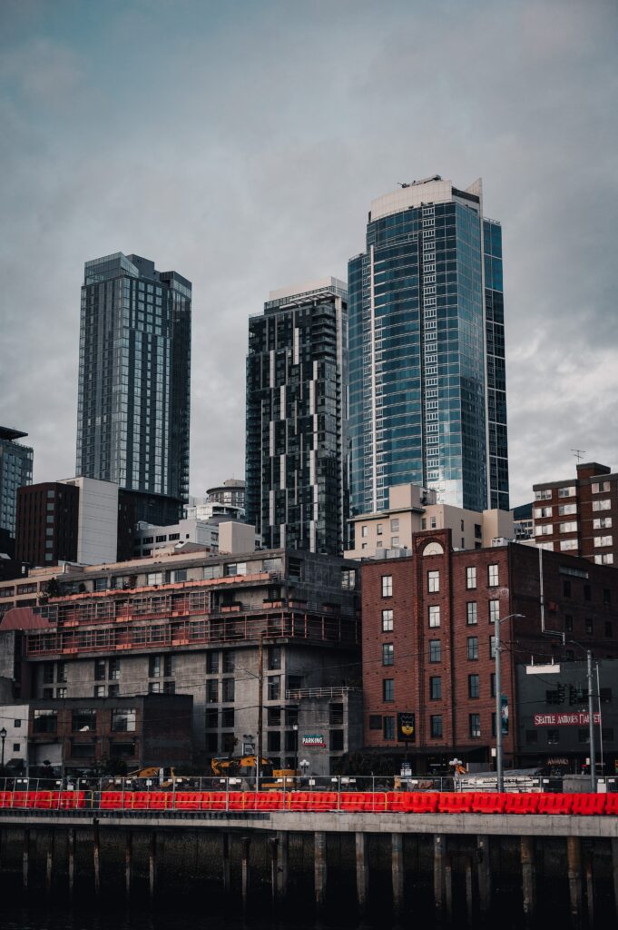 Modern Urban Cityscape Wallpaper: Skyscrapers & Design Against Clouds