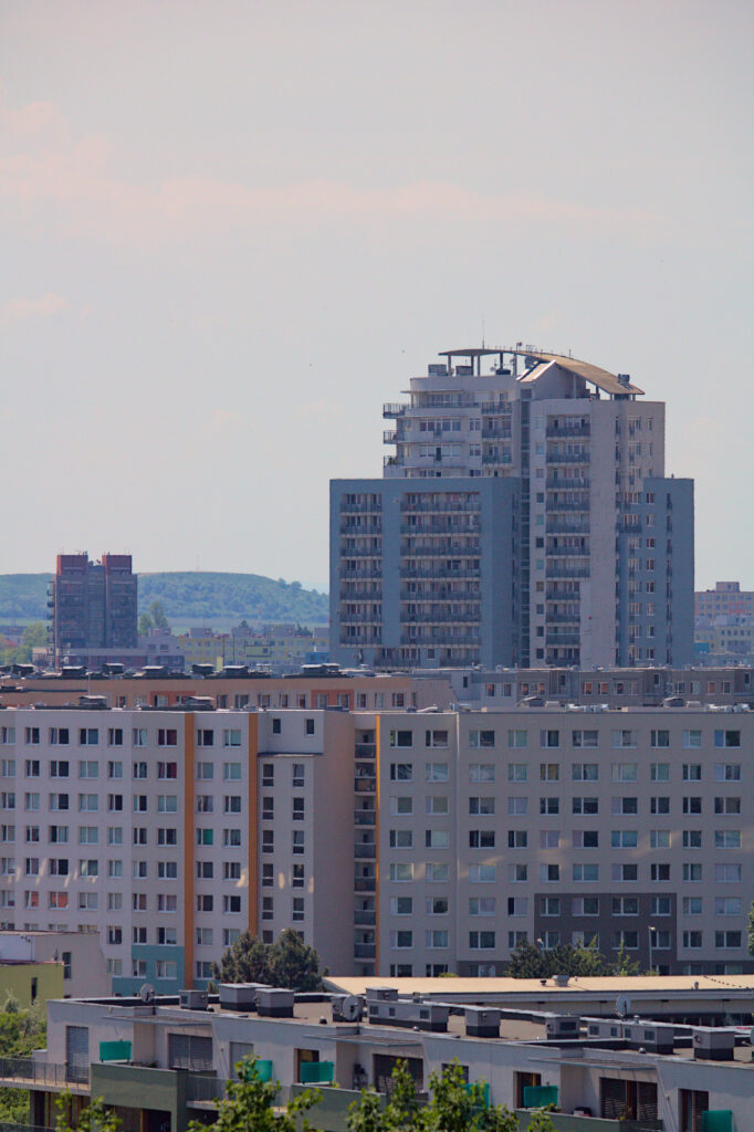 Urban Cityscape Wallpaper: Modern Architecture & Scenic Hills