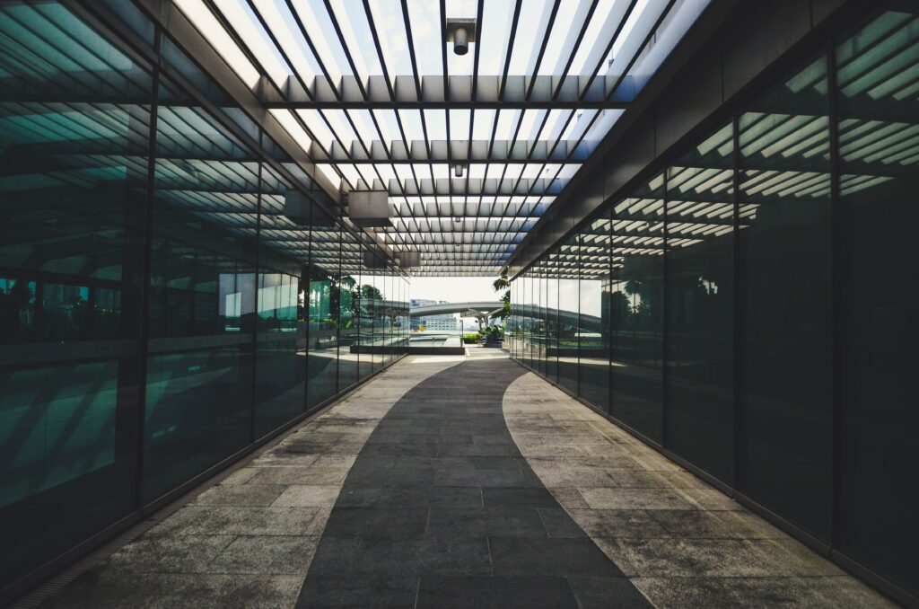 Modern Architectural Wallpaper: Sleek Glass Structure & Symmetrical Pathway