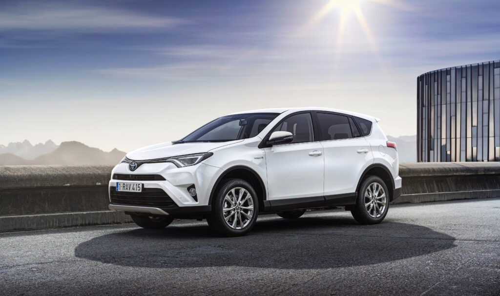 Sleek White Toyota RAV4 Wallpaper with Serene Outdoor Background