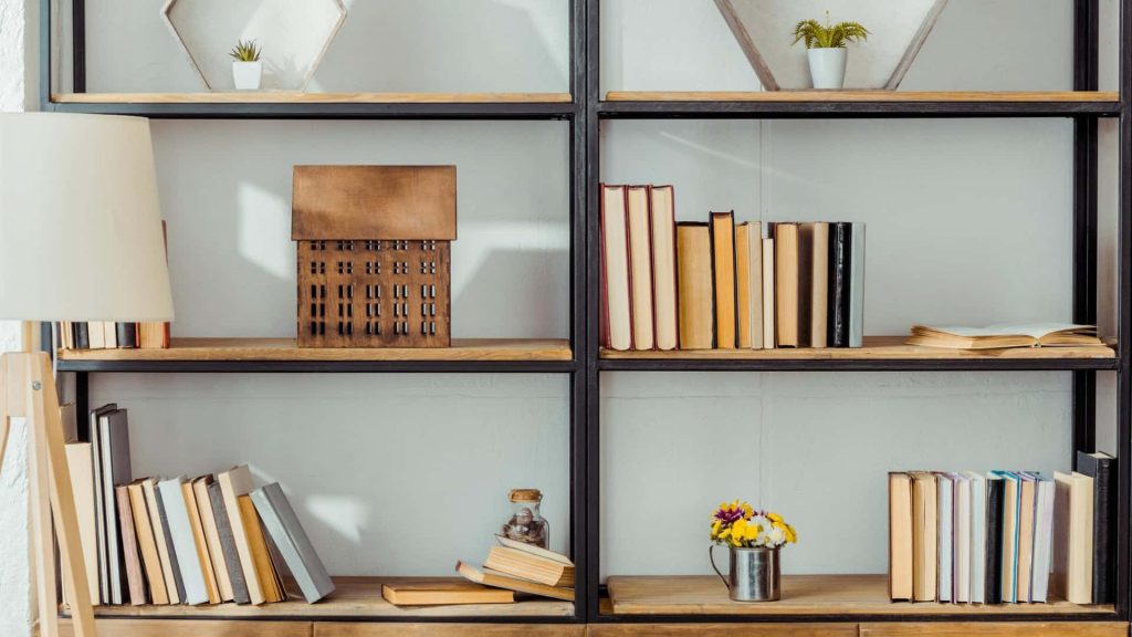 Modern wooden bookshelf wallpaper with books succulents model house and soft lamp for Zoom background