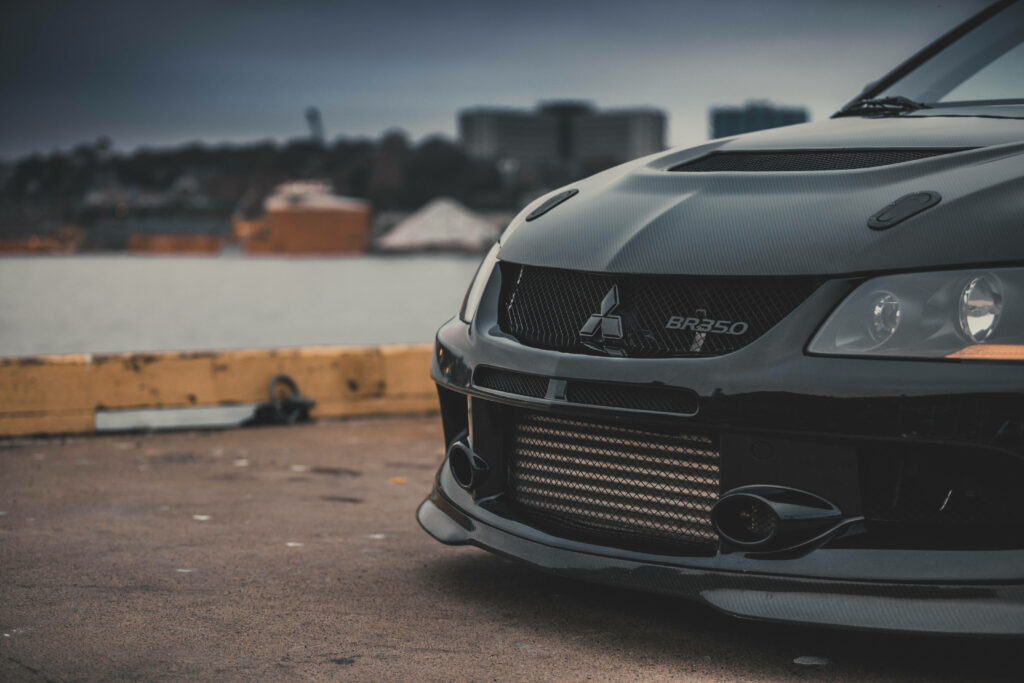 Urban Mitsubishi Wallpaper: Sleek Modified Car with Carbon Fiber Detail