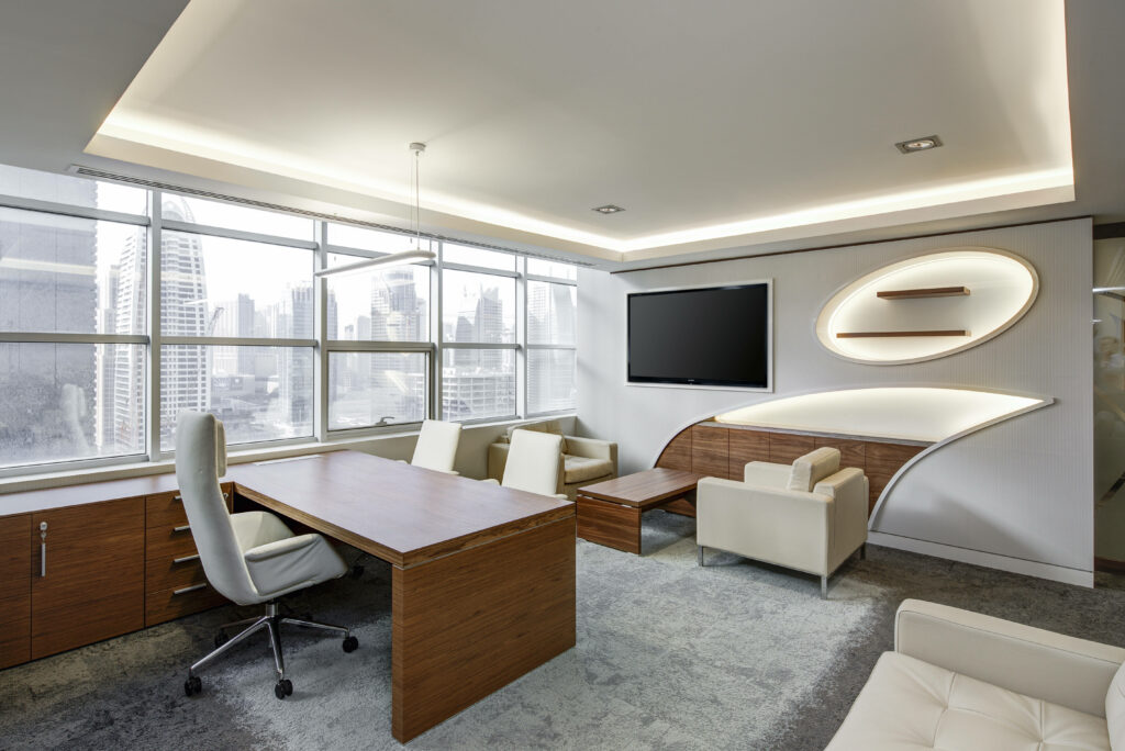 Modern executive office with modular wood furniture leather seats and large city skyline windows Wallpaper