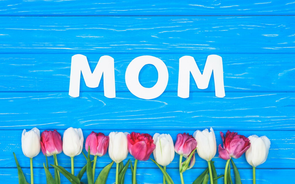 Mom's Love Blossoms on Mother's Day: Vibrant Tulips on Blue Wooden QHD Wallpaper