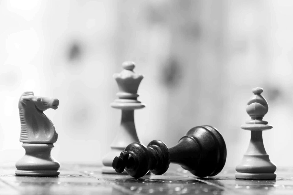 Intense Chess Battle: Monochrome Wallpaper with Wooden Chessboard
