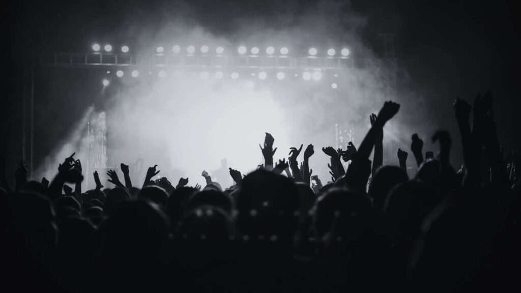 Monochromatic Concert Wallpaper: Energetic Crowd & Dramatic Lights