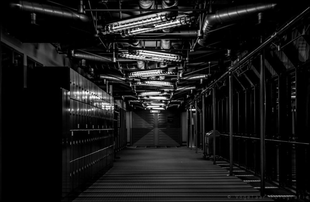 Monochromatic Factory Hallway Wallpaper: Industrial Precision Background