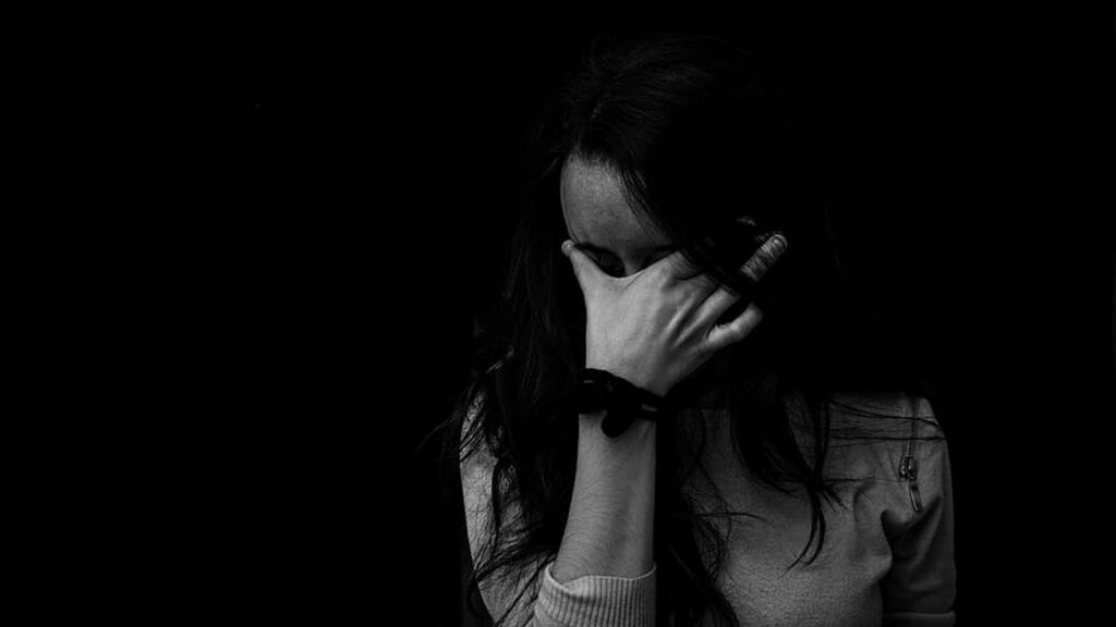 Monochrome Melancholy: HD Wallpaper of Depressed Girl in Black Background
