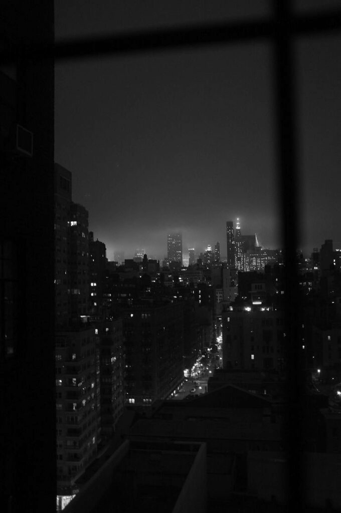 Moody Monochromatic Cityscape Wallpaper: Nighttime Window View
