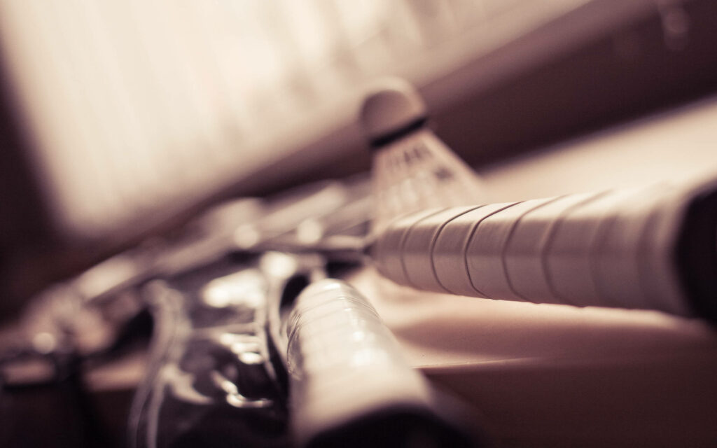 Vintage Sepia Composition Emphasizing the Racket's Dynamic Handles Wallpaper