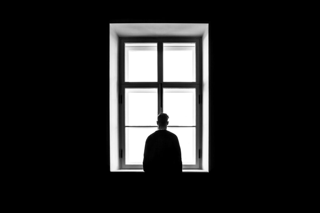 Monochromatic Wallpaper: Solitary Figure by Window - Mood of Solitude