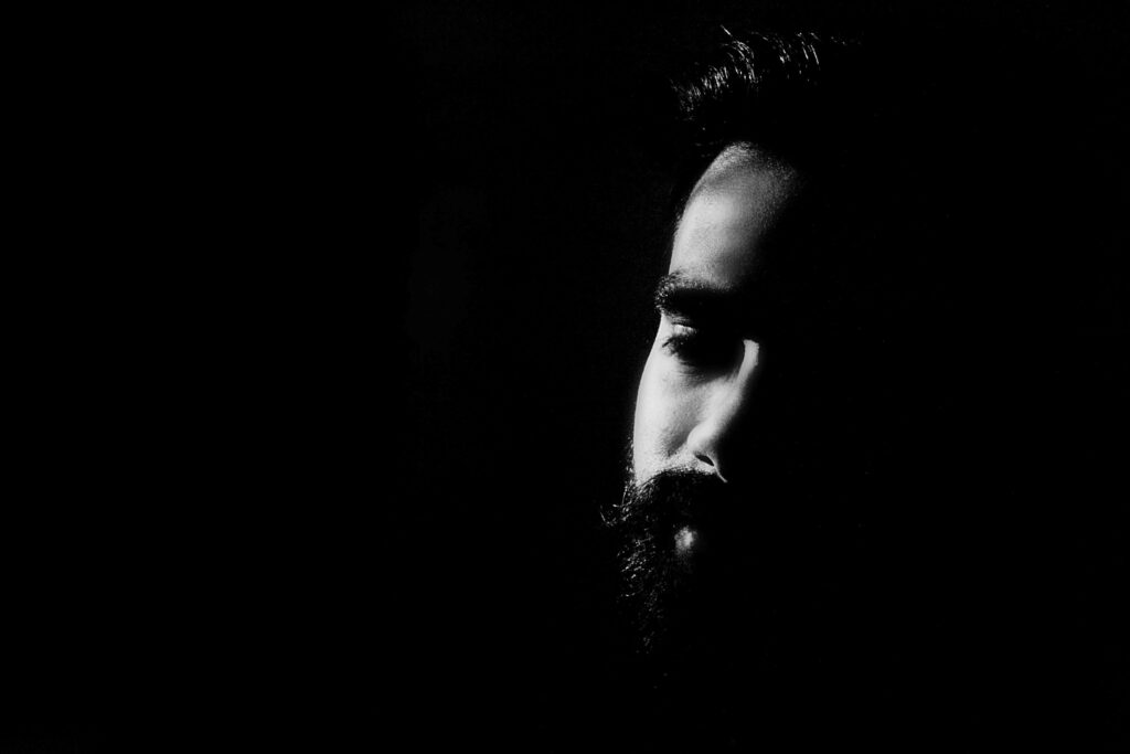 Monochrome Bearded Man Wallpaper: Dramatic Light & Shadow Effects