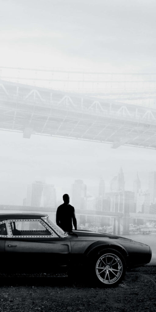 Monochromatic Bridge Scene: Urban Skyline with Car and Figure Wallpaper