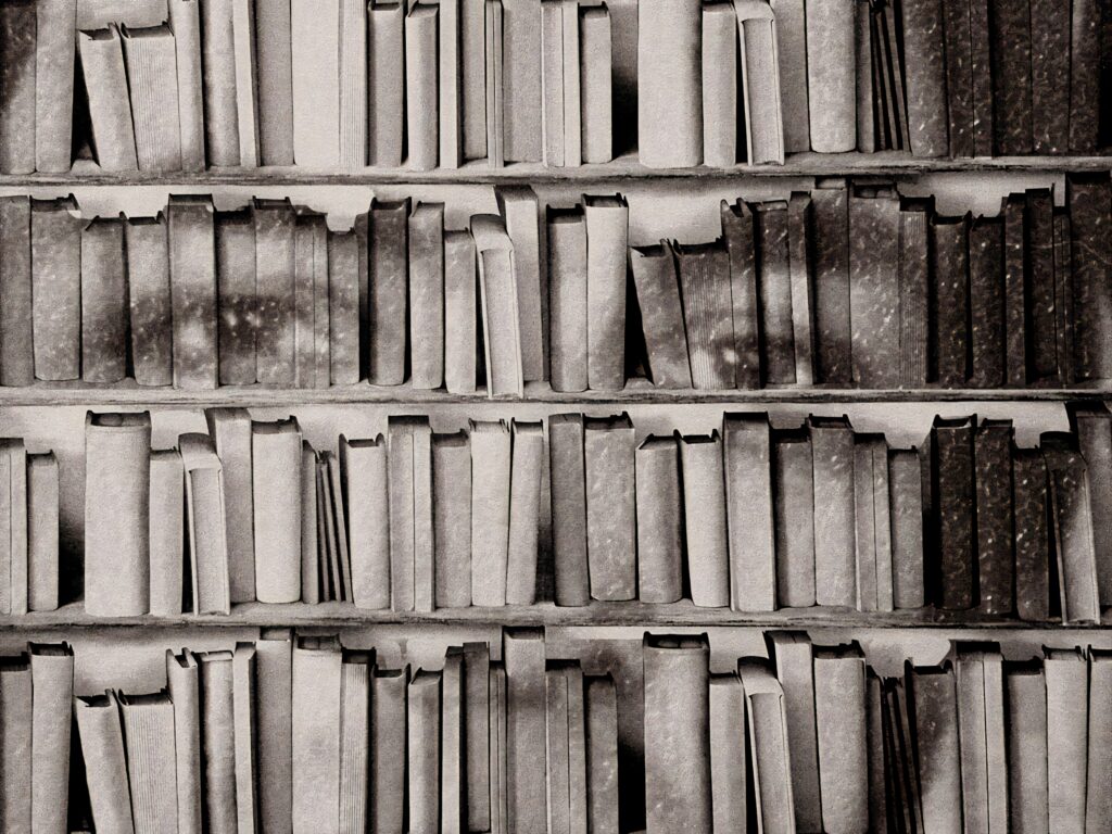 Creative monochrome bookshelf art forming a man's portrait blending literature and visual design Wallpaper