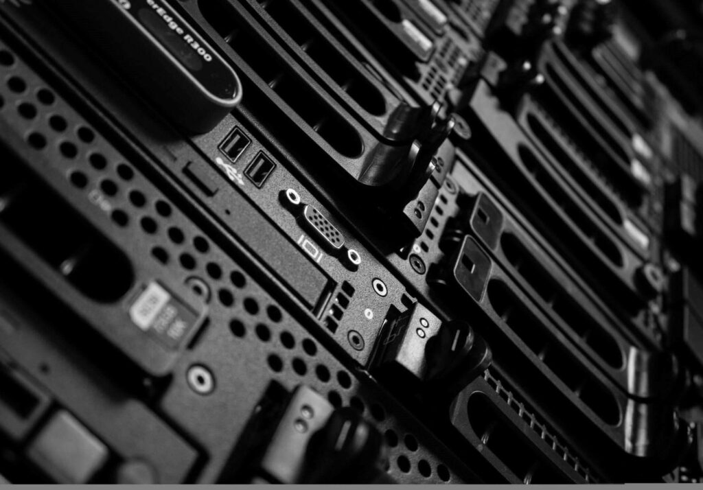 Close-up of black and white data center server rack with vented panels and connectors wallpaper background