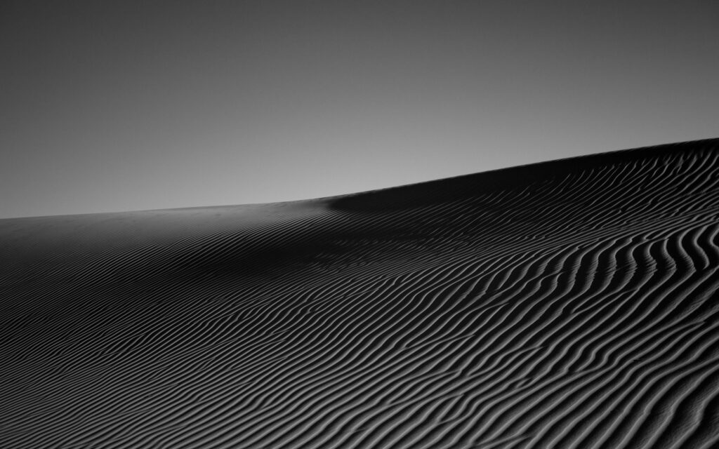 Monochrome Desert Sand Dunes Wallpaper: Textured Black & White Background