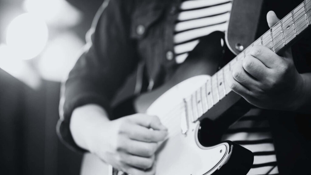 Dynamic Monochrome Wallpaper: Close-Up of Electric Guitarist