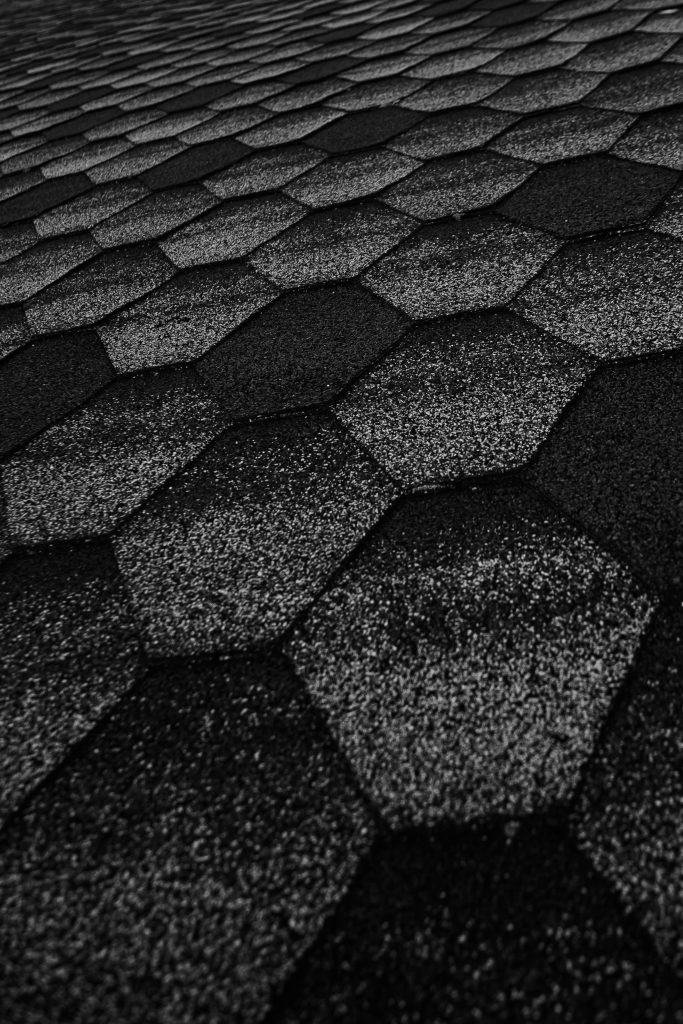Monochrome hexagon wallpaper with textured shingles pattern in black and white geometric design