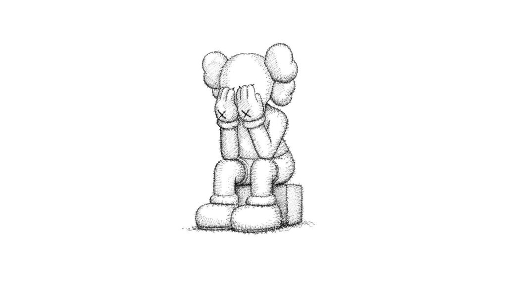Monochrome Kaws character sitting on block with head in hands expressing sadness wallpaper background