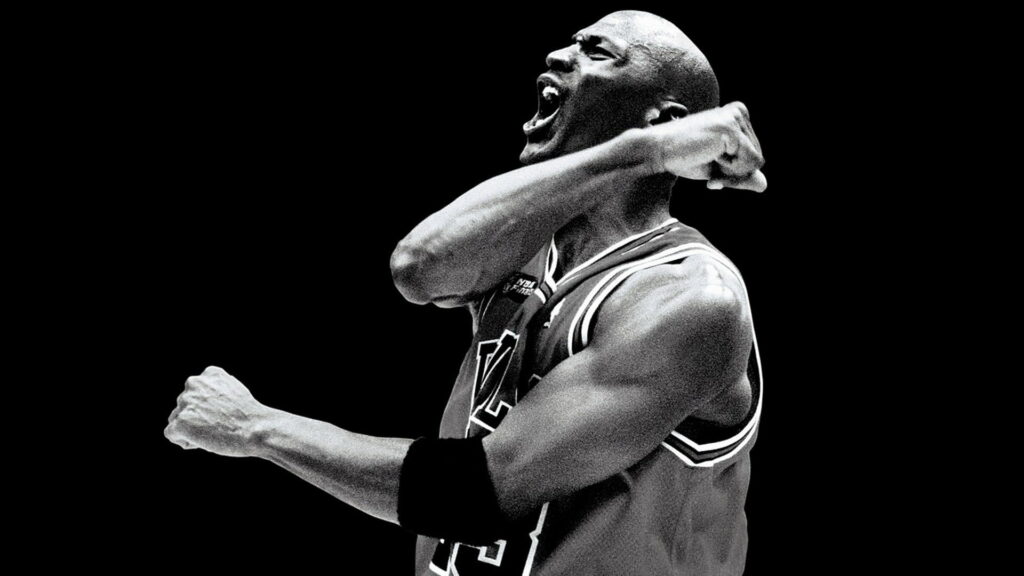 Airborne Grayscale Glory: Michael Jordan and the Monochrome Chicago Bulls Dominate the NBA Wallpaper