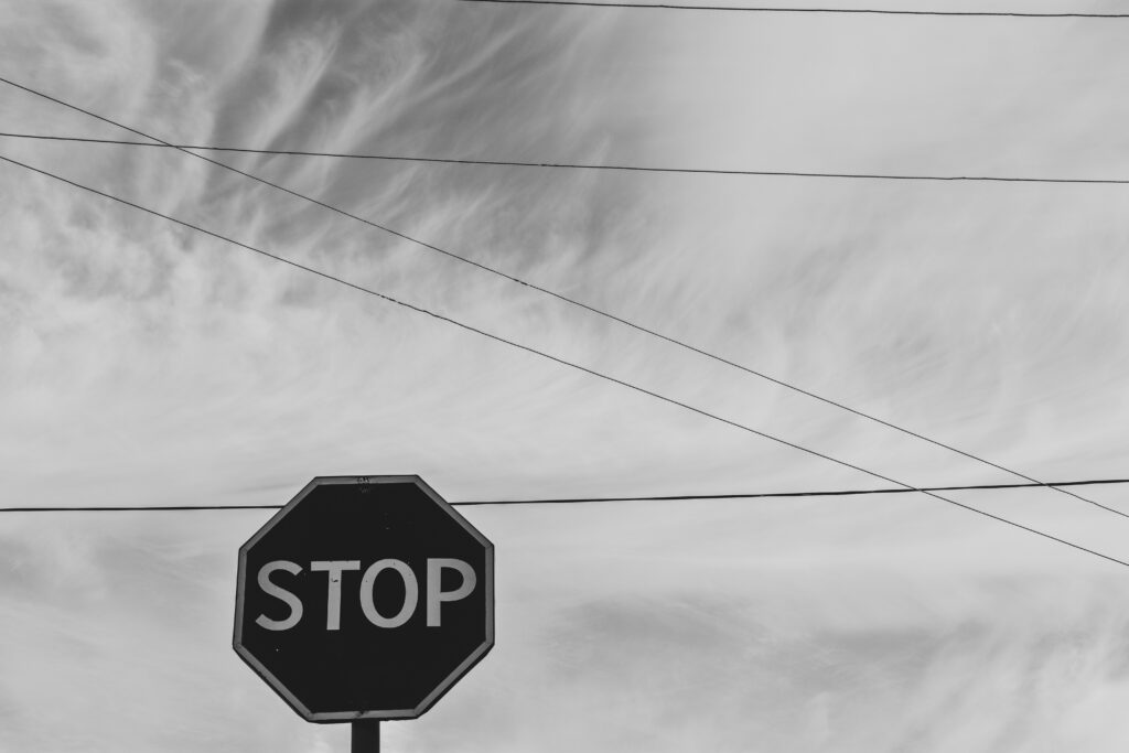 Minimalist Black-and-White Wallpaper: Stop Sign & Dramatic Sky