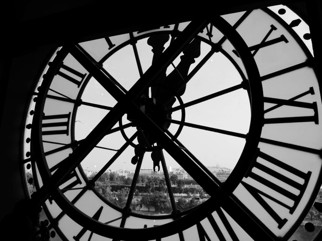 Monochrome Wallpaper: Intricate Tower Clock with Cityscape View