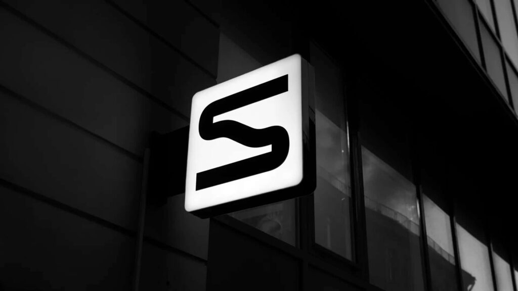Bold Monochrome S Wallpaper Against Industrial Background Design