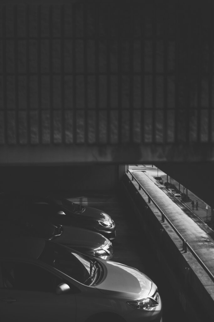 Monochrome Car Parking Garage Wallpaper: Dramatic Black & White Depth