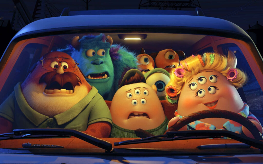 Monsters University Wallpaper: Colorful Characters in a Fun Vehicle Scene