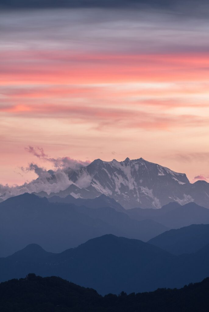 Monte Rosa summit near Zermatt alpine mountains with pink purple sunrise foggy sky wallpaper background