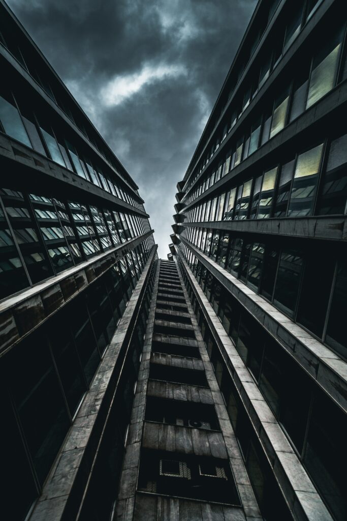 Stunning Towering Buildings Under Moody Sky | Dramatic Wallpaper