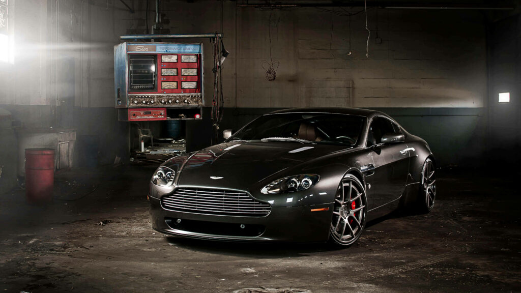 Sleek Aston Martin V12 Vantage Wallpaper in Industrial Setting