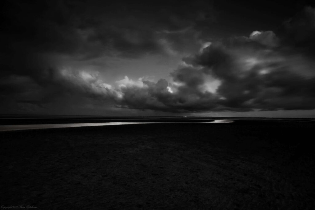Moody Black and White Sky Wallpaper with Dark Landscape and Water Reflection